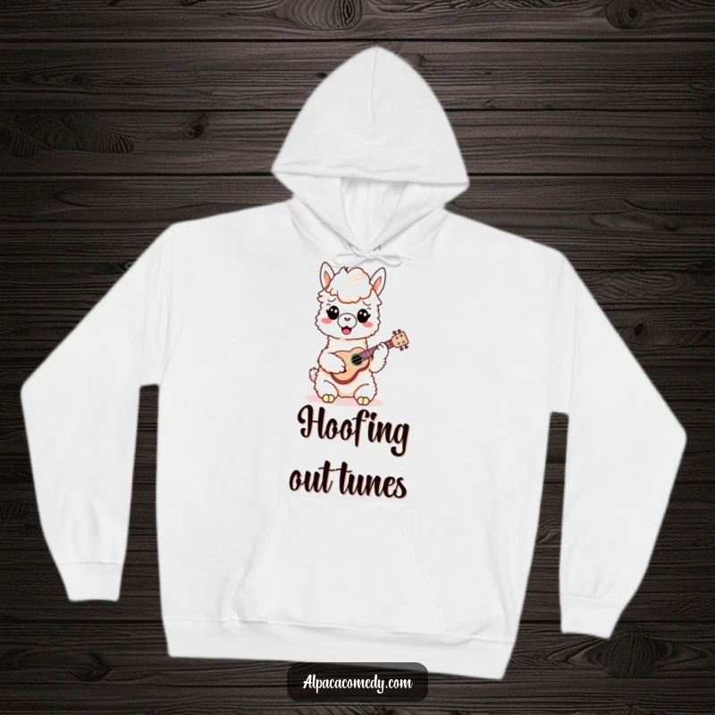 Funny Alpaca Hoodie: A cheerful alpaca sits comfortably, playing a miniature ukulele with its hooves, embodying pure musical bliss.